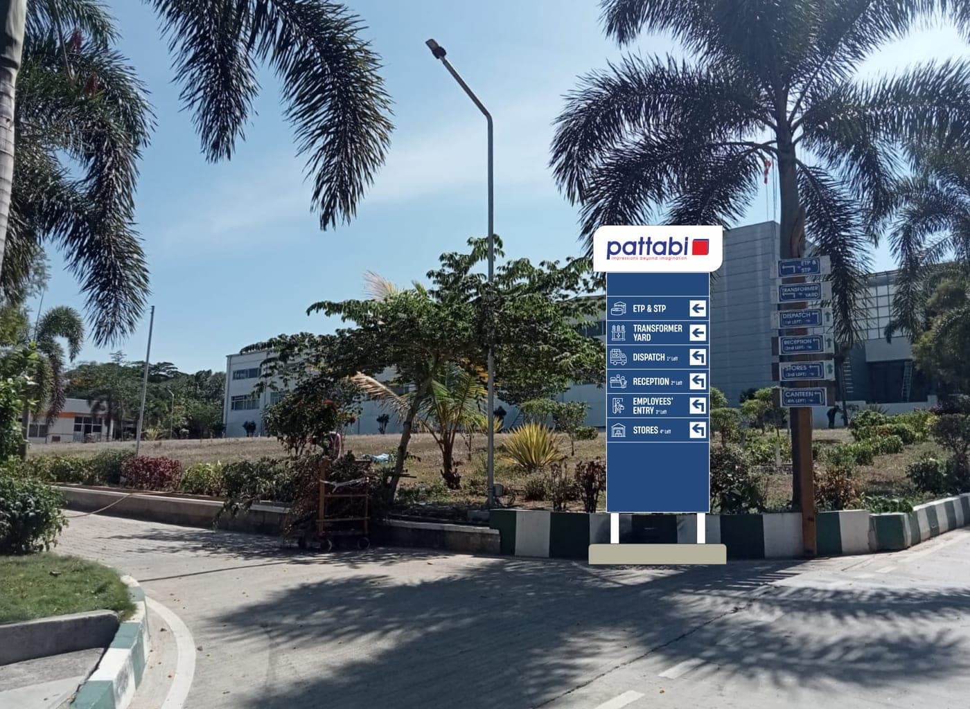 Pattabi direction board installed beside an industrial driveway